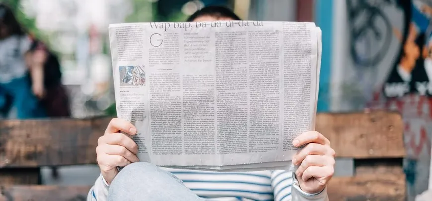 Person reading a newspaper