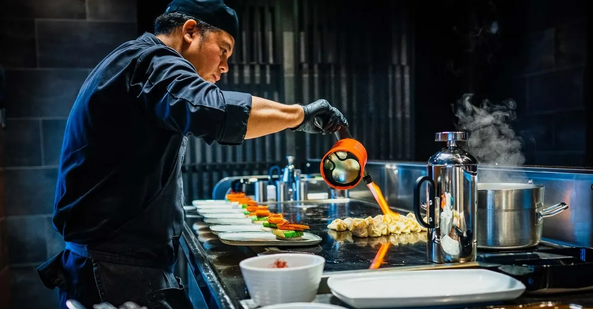 chef putting finishing touches to food