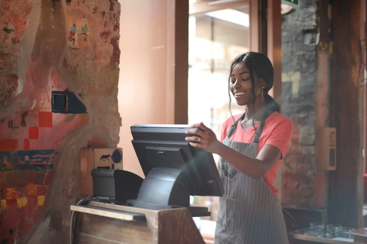 pexels-andrea-piacquadio-3801422 woman stood at till in restaurant